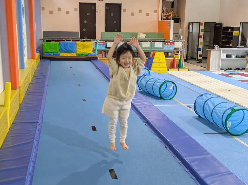 トランポリンで跳ねる女の子の写真